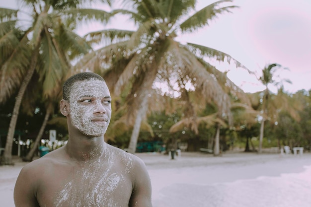 Touriste noir avec masque de sable curatif