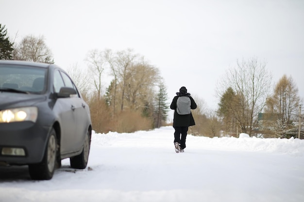 Les touristes voyagent à travers le pays enneigé. En chemin, marchez et faites du stop.