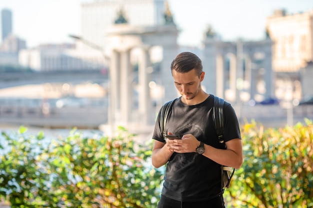 Touristique de l'homme avec smartphone et sac à dos dans la rue de l'Europe.