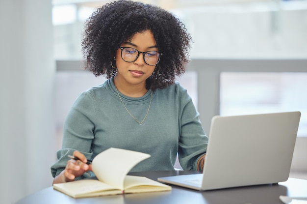 Tout se déroule comme prévu Photo d'une jolie jeune femme d'affaires assise seule dans son bureau et travaillant