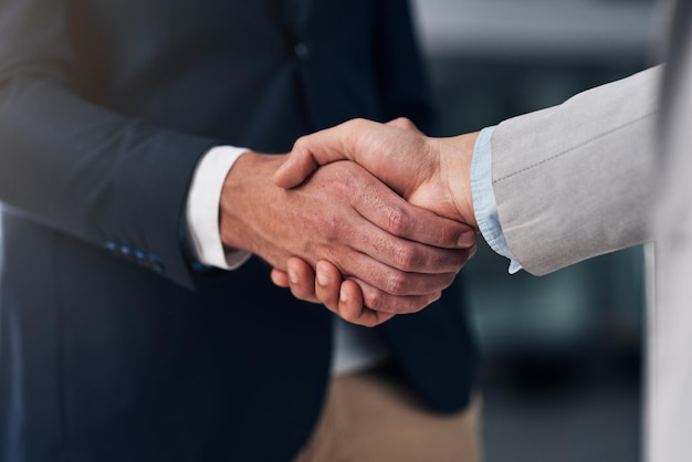 Tout se résume à faire confiance Photo recadrée de deux hommes d'affaires se serrant la main dans un bureau moderne