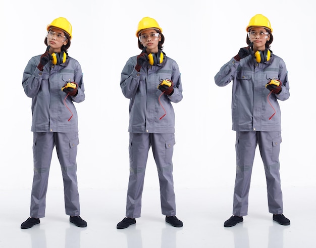 Toute la longueur des années 20 jeune femme de l'industrie asiatique portant un casque de protection pensant mot dur