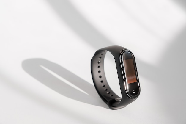 Tracker de fitness intelligent isolé sur fond clair de matin blanc. Bracelet sport. Tracker de course de groupe de fitness. Montre de fitness noire.