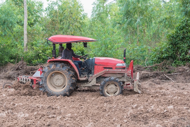 Tracteur labourant le sol dans le jardin pour la culture de légumes.