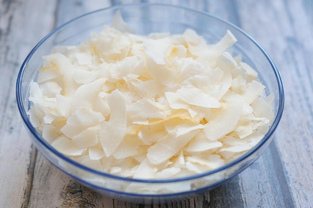 Tranche de flocons de noix de coco frais dans un bol sur une table