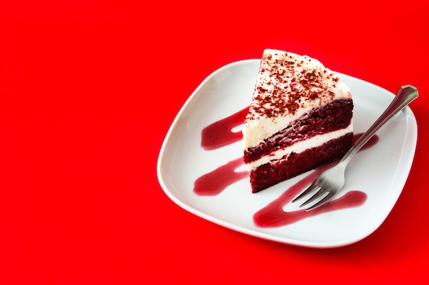 Tranche de gâteau de velours rouge sur fond rouge