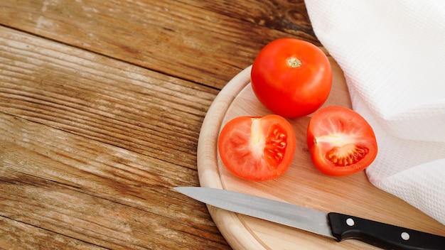 Tranche de tomate sur une planche à découper en bois