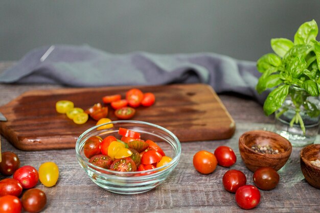 Trancher les tomates cerises anciennes sur une planche à découper en bois.