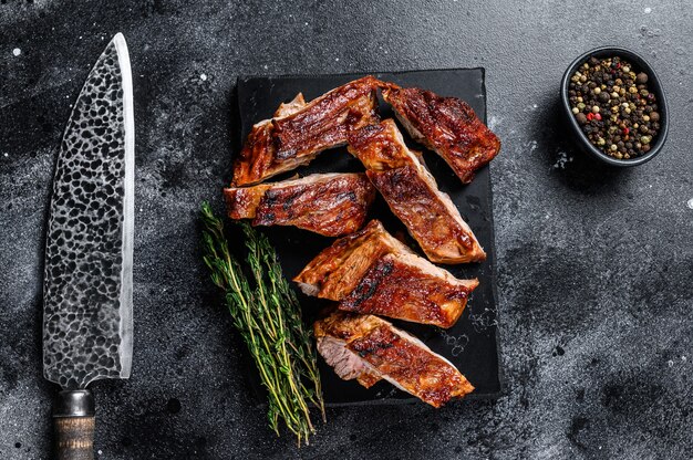 Tranches de viande de côte de veau grillée avec couteau de boucher.