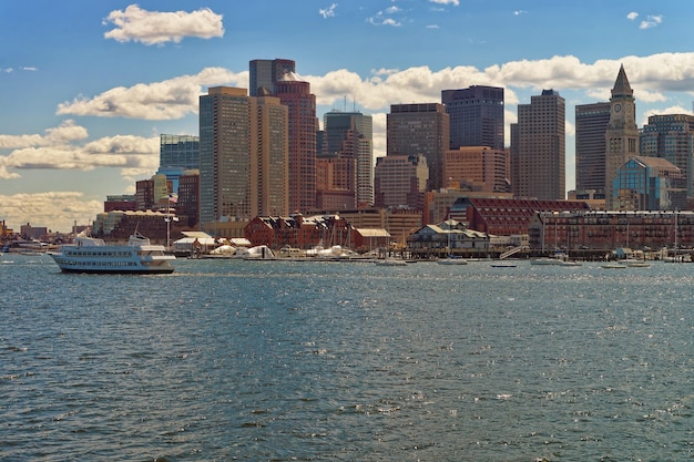 Transport par eau traversant la rivière avec l'horizon de la ville en arrière-plan à Boston, aux États-Unis. La ville est située à proximité de diverses installations d'eau. Les navires et les bateaux y sont très populaires.