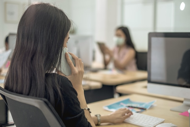 Travail professionnel au bureau avec mise en quarantaine de distance sociale de masque facial pendant COVID19 affect