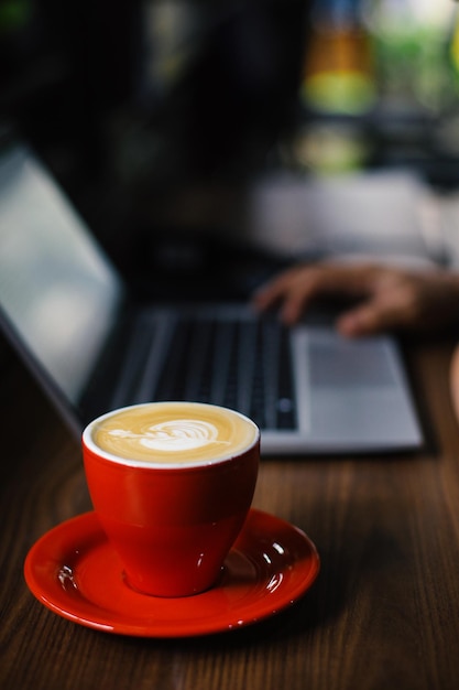 Travailler en ligne sur un ordinateur portable avec du café