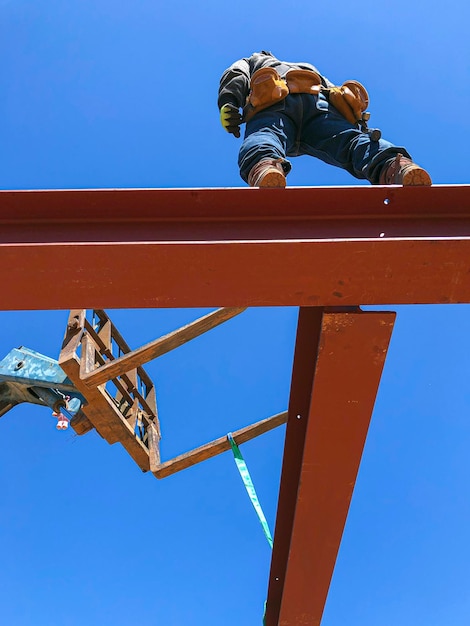 Travailleur de la construction de charpente plaçant une poutre métallique