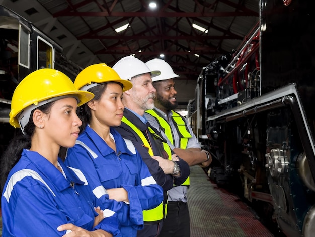 Travailleur d'équipe ingénieur de l'industrie enseignant aider un ami à utiliser une machine lourde de contrôle en usine