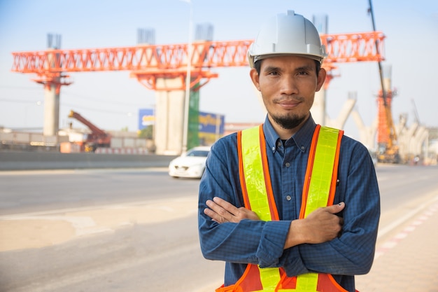 Photo travailleur ingénieur homme asiatique debout sur la construction du site, casque d'architecture protéger le contrôle de l'ouvrier