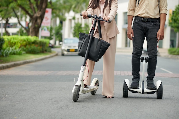 Travailleurs de l'entreprise informatique sur des scooters électriques