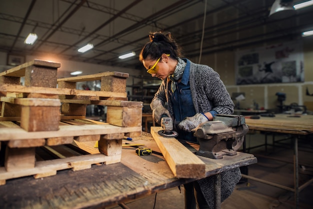 Travailleuse mature dans l'atelier de menuiserie