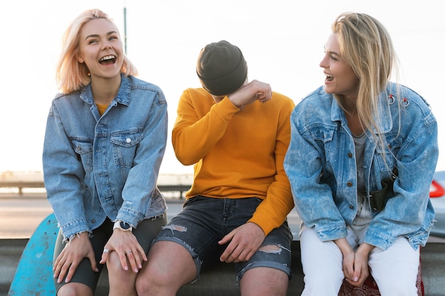 Trois amis positifs rient dans une rue