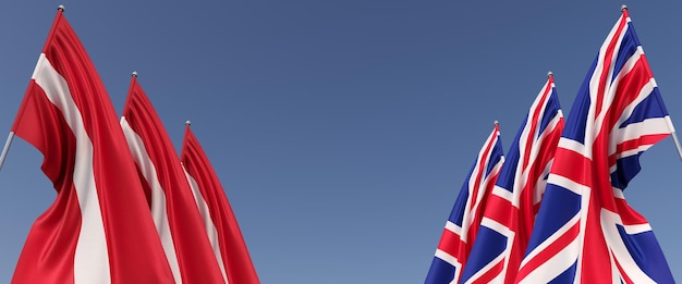 Trois drapeaux du Royaume-Uni et de la Lettonie sur des mâts sur les côtés Drapeaux sur fond bleu Place pour le texte Grande-Bretagne Londres Angleterre Riga Commonwealth Illustration 3D