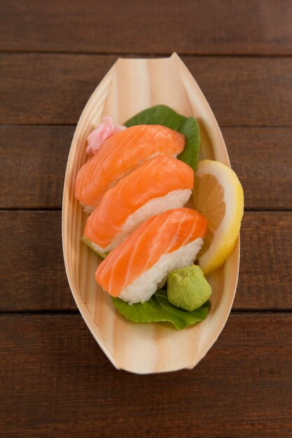 Trois nigiri sushi servis dans une assiette en bois