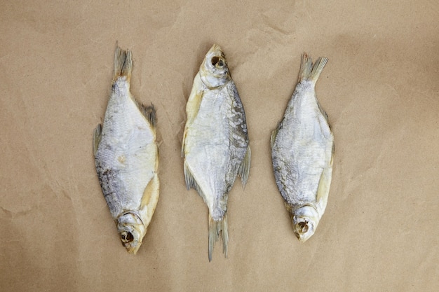 Trois poissons secs sur papier sulfurisé