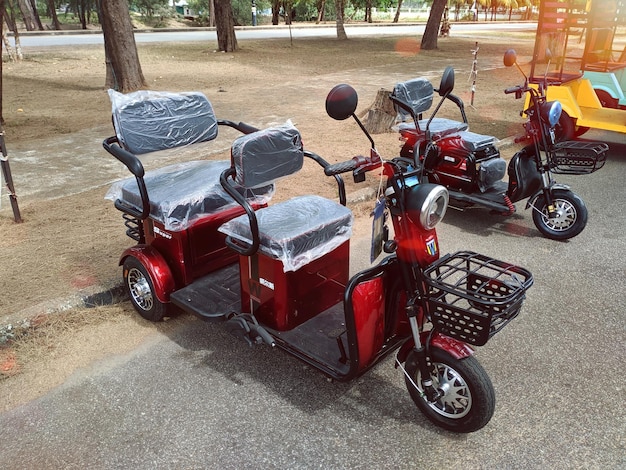 Photo trois scooters sont garés dans une rue avec un sac de plastique dessus.