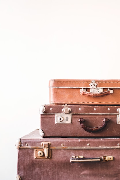 Trois vieilles valises vintage sur un fond de mur lumière. Style rétro rustique