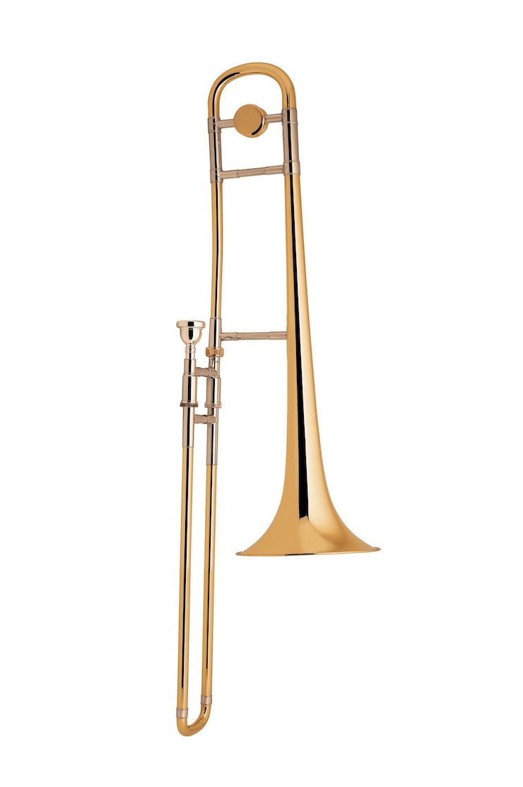 Photo le trombone en laiton isolé sur blanc