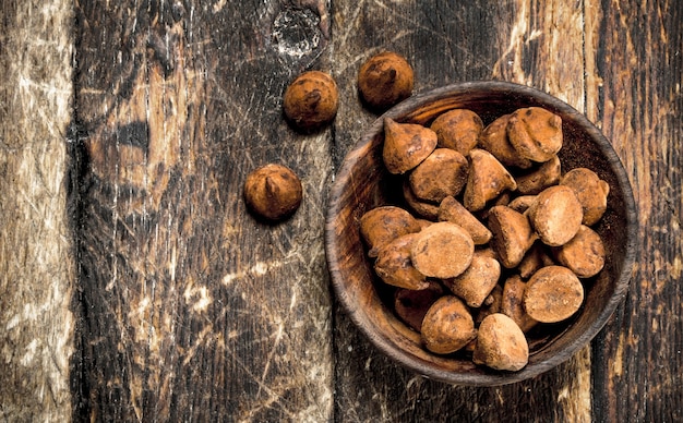 Truffes au chocolat dans un bol. Sur un fond en bois.