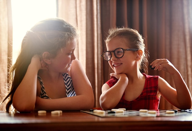 Tu sais que je vais gagner juste Photo de deux petites filles jouant à un jeu de société