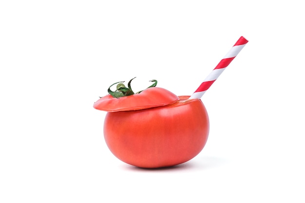 Tube de cocktail dans une tomate tranchée isolée sur fond blanc.