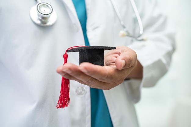 Étude de médecin asiatique apprendre avec chapeau d'écart de graduation dans la salle d'hôpital concept de médecine d'éducation de génie brillant intelligent