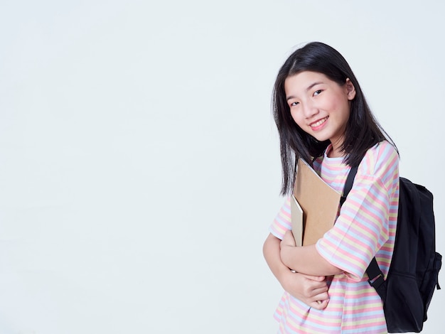 Étudiante tenant des livres avec des sacs à dos.