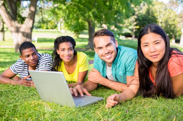 Étudiants souriants avec ordinateur portable sur le campus