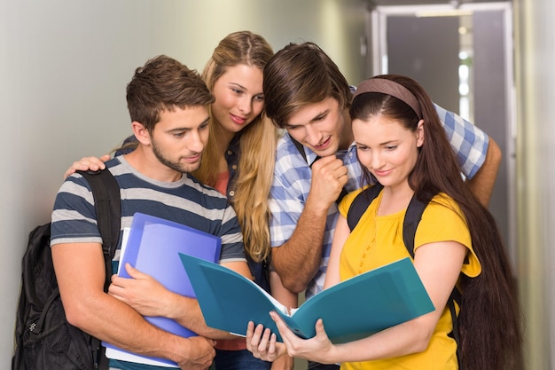 Étudiants tenant des dossiers au couloir du collège