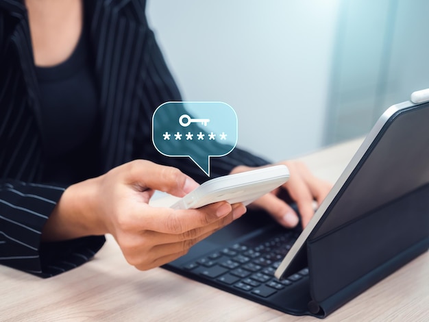Two factor authentication or 2FA cyber security technology concept Asterisk hidden password with key icon in business person hand while look otp code on smartphone for log in by laptop computer