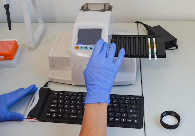 Photo uranalysis ph test d'échantillon d'urine dans le tube rapport médical boîte de pétri et formulaires hand holding test ph