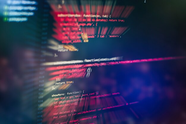 Utilisation de CSS, JavaScript et HTML. Surveiller le gros plan du code source de la fonction. Contexte abstrait de la technologie informatique. Code source du logiciel.