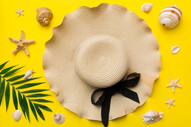 Photo vacances d'été concept d'été avec chapeau de paille et feuille tropicale mise à plat vue de dessus copie espace