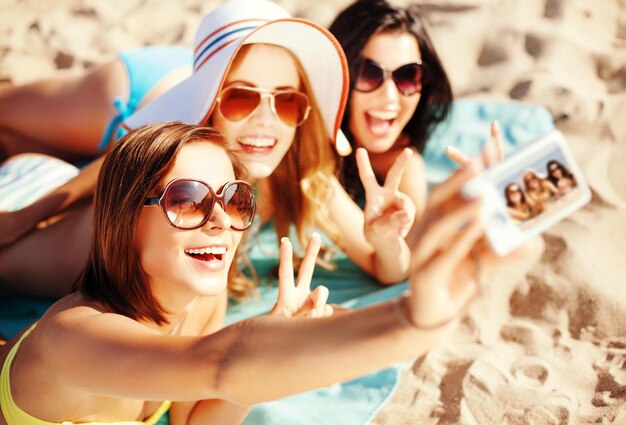 vacances d'été, vacances et concept de plage - filles se prenant en photo sur la plage