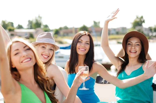 vacances d'été et vacances - filles avec des verres de champagne sur un bateau ou un yacht