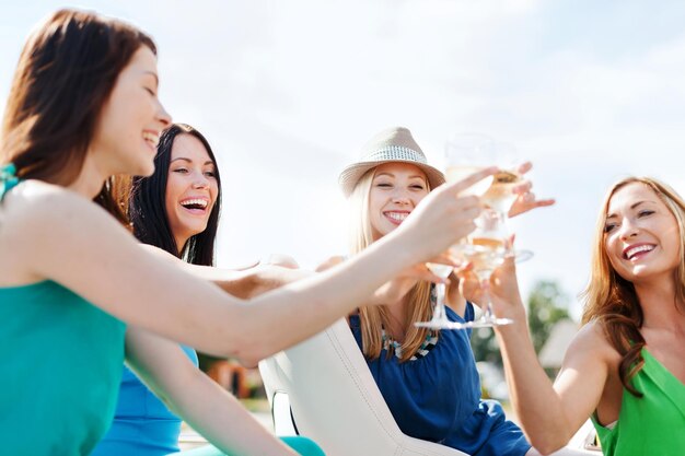 vacances d'été et vacances - filles avec des verres de champagne sur un bateau ou un yacht