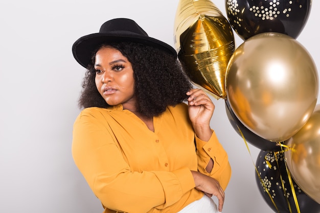 Vacances, fête d'anniversaire et concept amusant - Portrait de jeune femme souriante afro-américaine