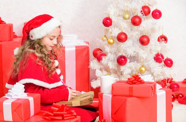 Vacances de Noël et du nouvel an Écrire une lettre au père Noël Tradition hivernale Enfant jolie fille écrivant une lettre électronique sur un ordinateur portable Lettre moderne pour le père Noël Envoyer un message au père Noël Père Noël en ligne