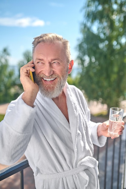 Vacancier masculin souriant pendant l'appel téléphonique