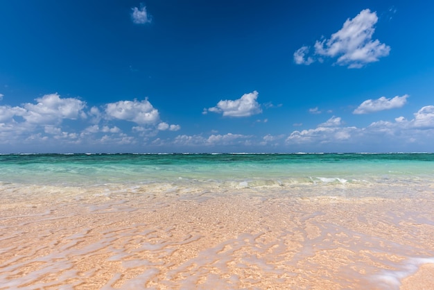 Photo vague cristalline douce de l'océan bleu sur la plage de sable mise au point sélective
