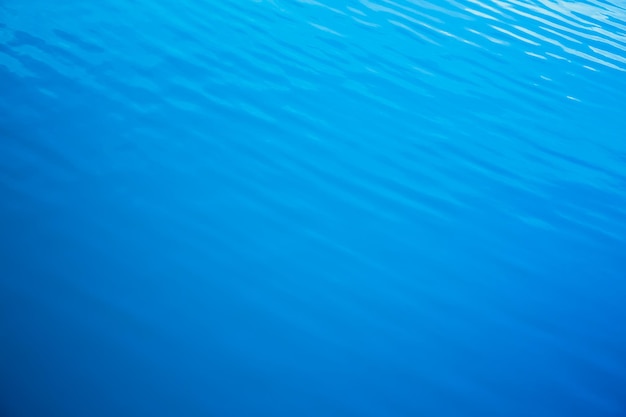 Vague d'eau de texture dans la piscine avec des reflets ensoleillés