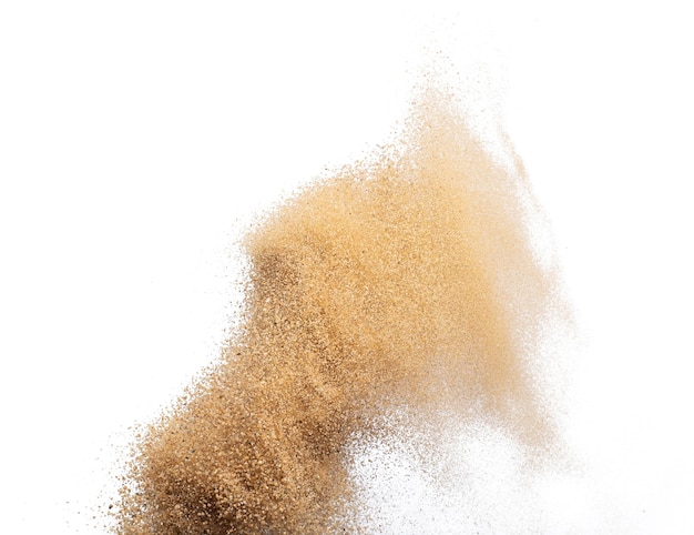 Une vague de sable doré explose Des nuages de sable abstraits volent Des éclaboussures de sable de couleur jaune jetées dans l'air