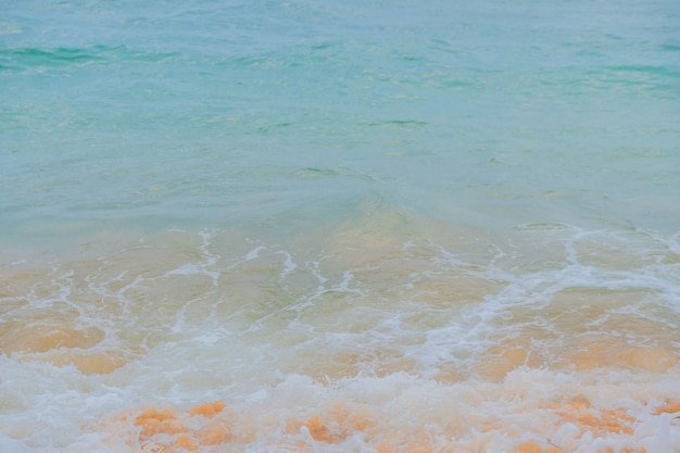 Vagues bleues de l&#39;océan et sable jaune de la plage.