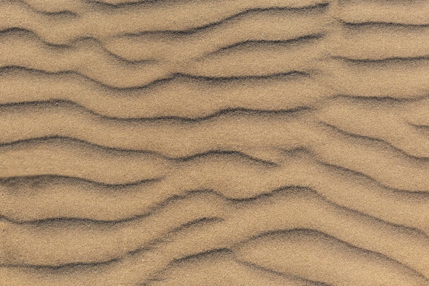 Les vagues des dunes et le motif du sable Vague Le sable change de forme en raison du vent pour former des ondulations de sable